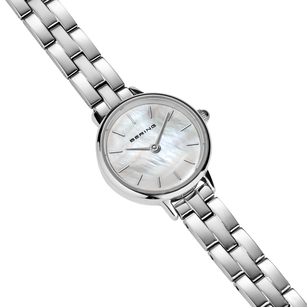 Diagonal overhead view of the pale mottled dial, silver-tone case and silver-tone link bracelet.