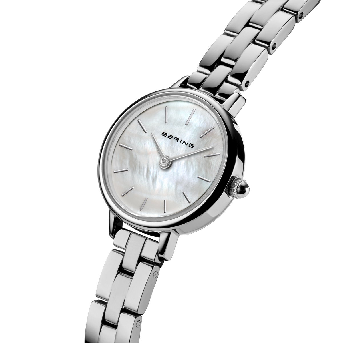 Angled close-up of the pale mottled dial and silver-tone case beside the silver-tone link bracelet.