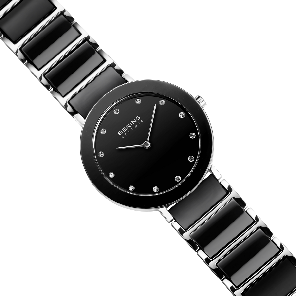 Diagonal overhead view of the black dial with bright dot markers, silver-tone with black bezel case and black-centered silver-tone link bracelet.