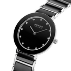 Angled close-up of the black dial with bright dot markers and silver-tone with black bezel case beside the black-centered silver-tone link bracelet.