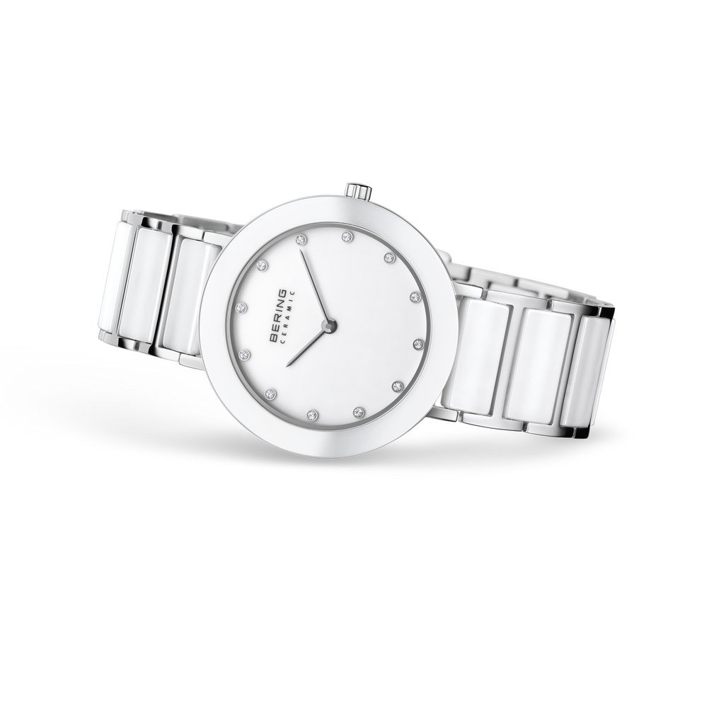 Angled watch view: white dial with bright dot markers and white-centered silver-tone link bracelet extended.