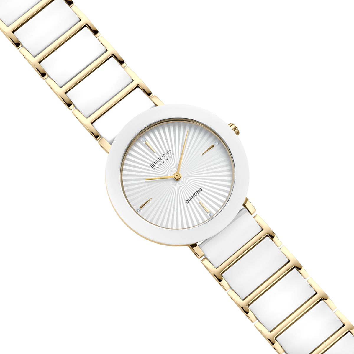 Vista diagonal desde arriba: esfera blanca con líneas radiales, caja dorada con bisel blanco y pulsera dorada de eslabones con centros blancos.