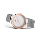 Angled watch view: pale dial with bright dot markers and silver-tone mesh strap extended.
