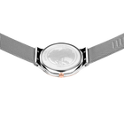Engraved watch case back with the silver-tone mesh strap extended to either side.
