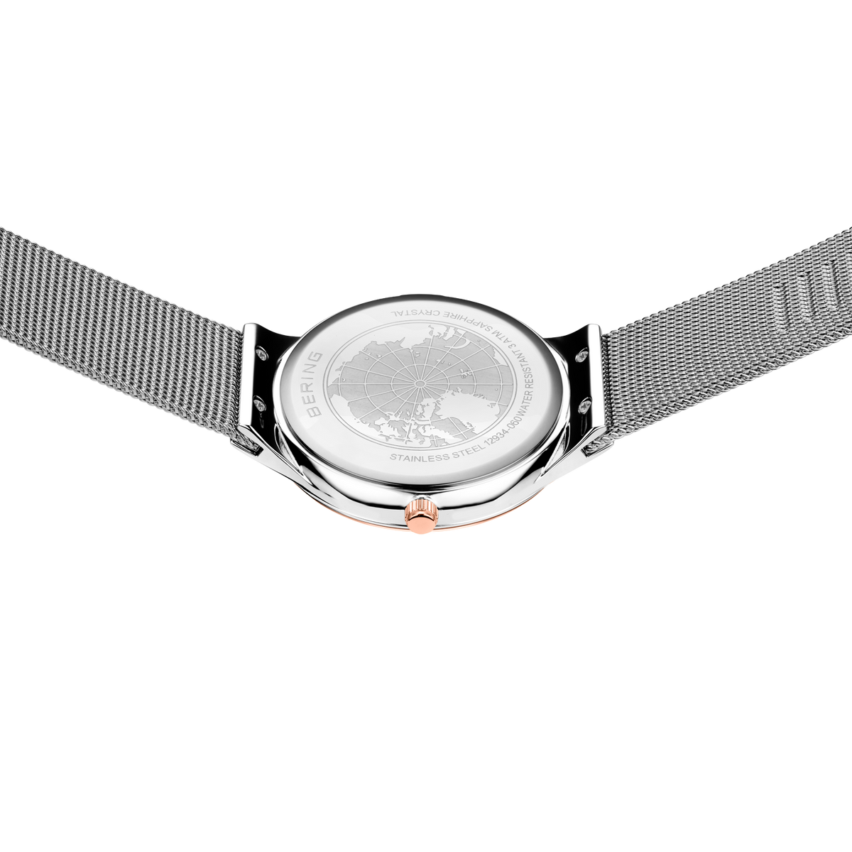 Engraved watch case back with the silver-tone mesh strap extended to either side.