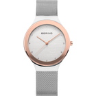 Front view: pale dial with bright dot markers, oval rose-tone case and silver-tone mesh strap.