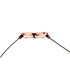 Side profile of the rose-tone watch case and crown between the ends of the grey mesh strap.
