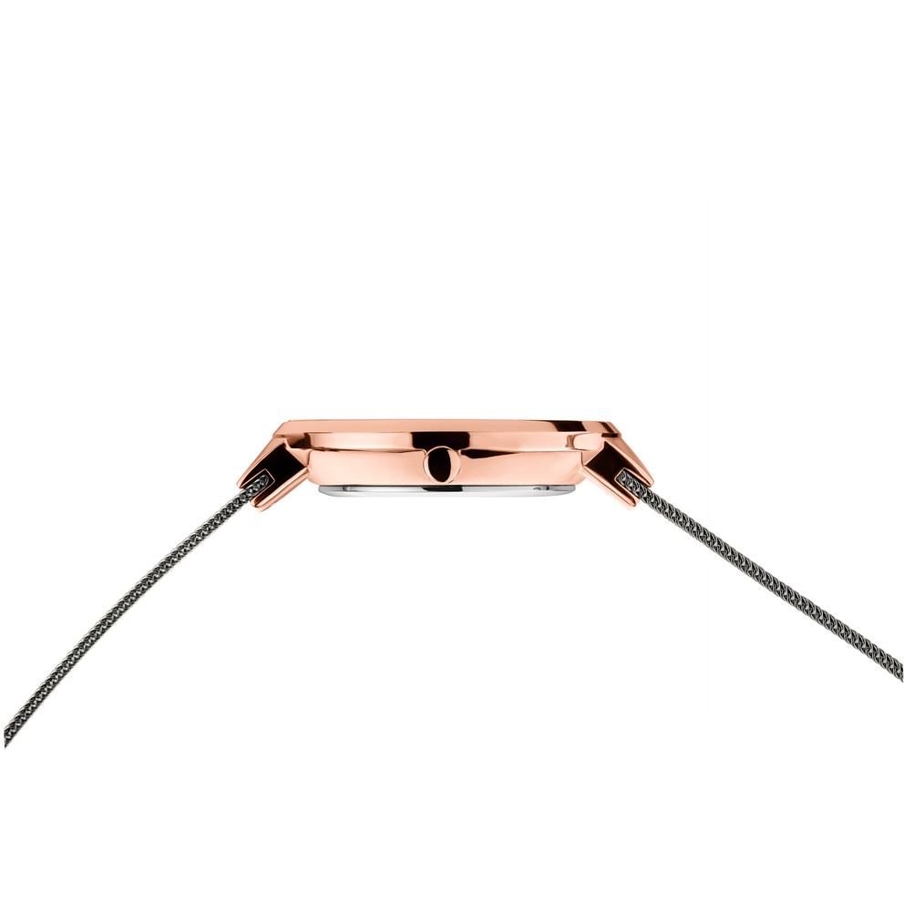 Side profile of the rose-tone watch case and crown between the ends of the grey mesh strap.