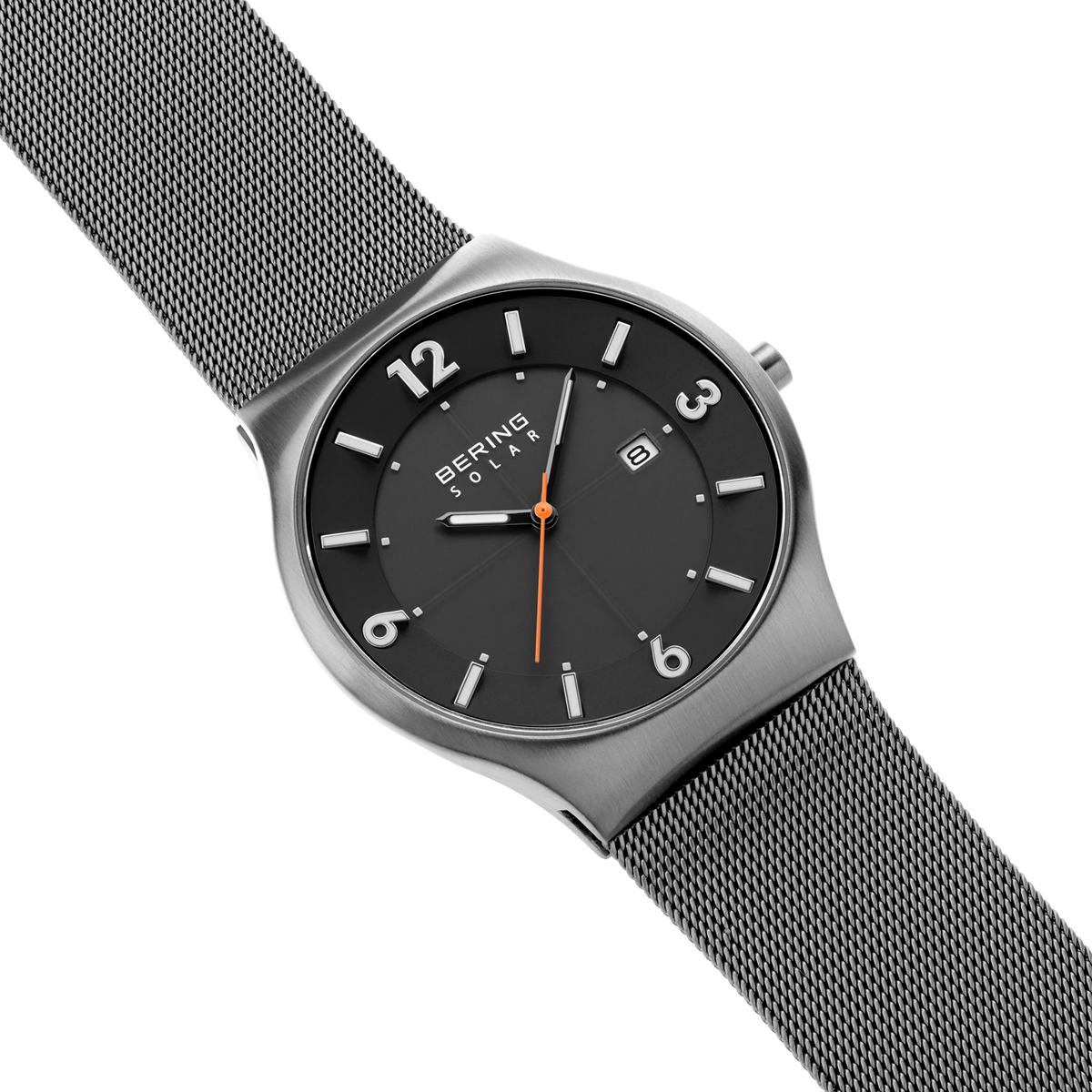 Diagonal overhead view of the dark grey dial with white numerals, dark silver-tone case and grey mesh strap.