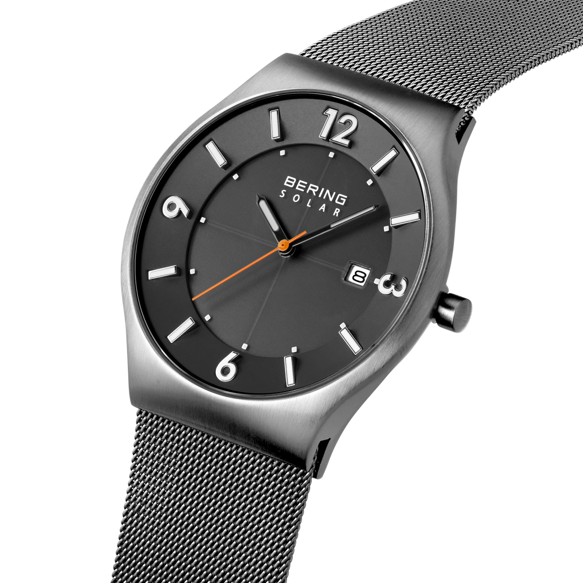 Angled close-up of the dark grey dial with white numerals and dark silver-tone case beside the grey mesh strap.