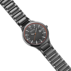 Diagonal overhead view of the grey dial with an orange outline, dark silver-tone case and grey link bracelet.