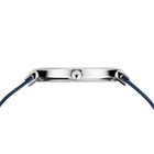 Side profile of the silver-tone watch case and crown between the ends of the blue mesh strap.