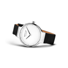 Reloj de esfera blanca apoyado en ángulo, con correa negra lisa extendida.