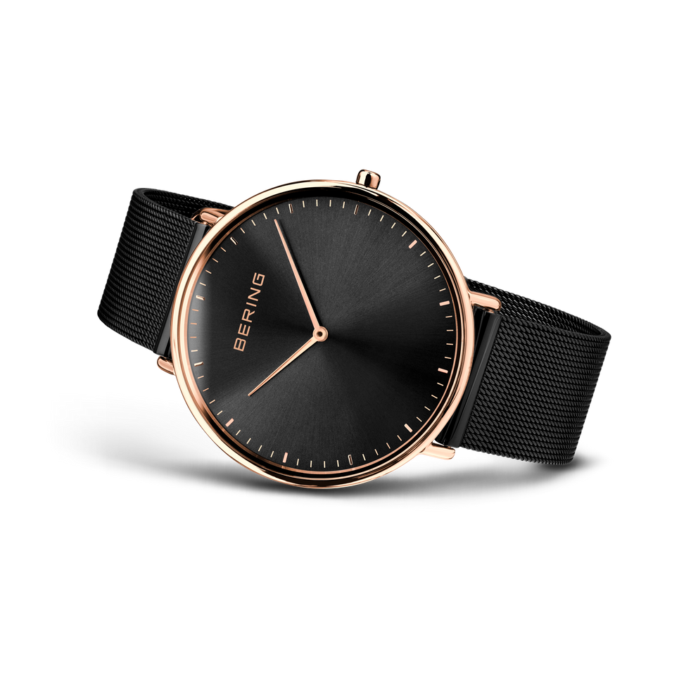Angled watch view: black dial and black mesh strap extended.