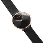 Diagonal overhead view of the black dial, rose-tone case and black mesh strap.