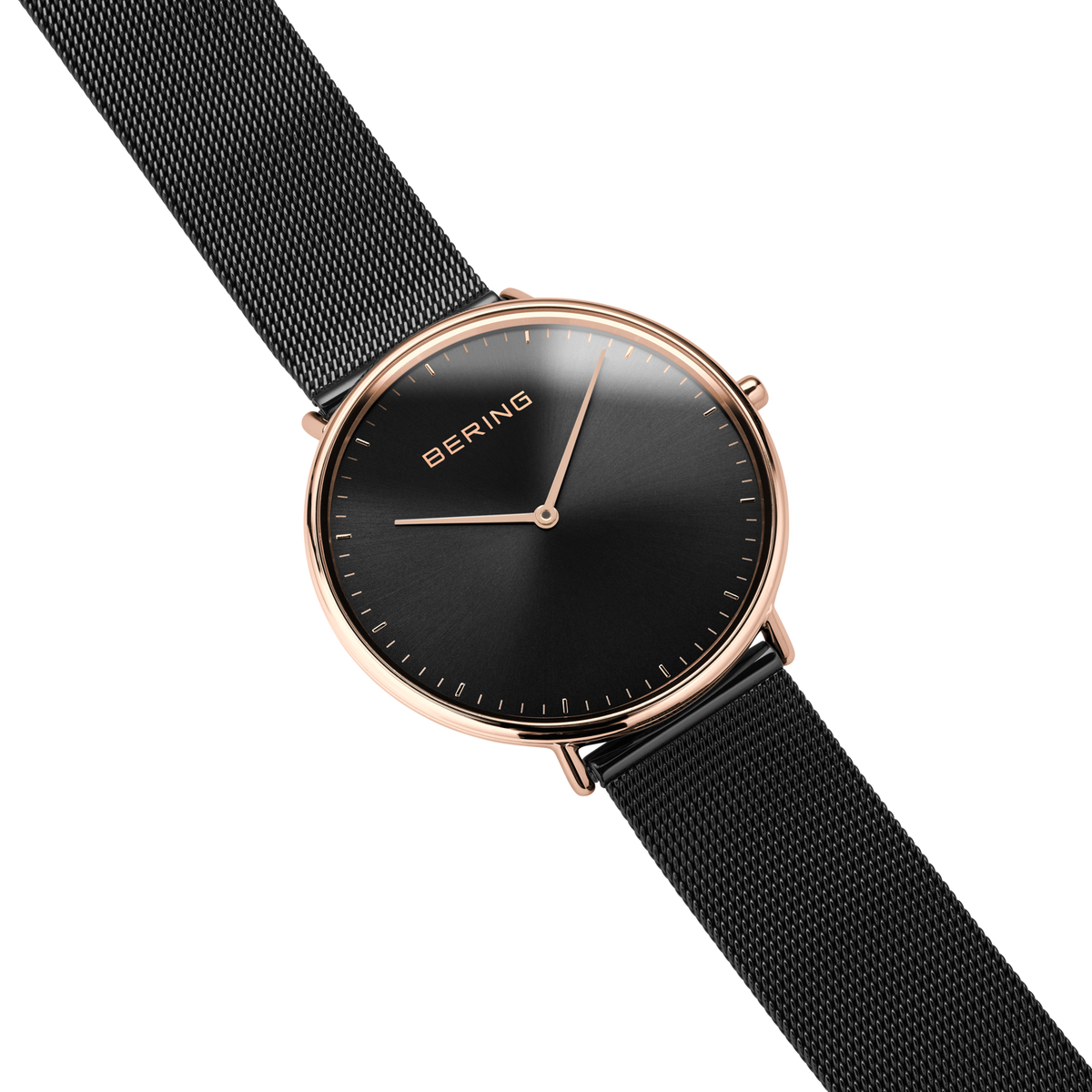 Diagonal overhead view of the black dial, rose-tone case and black mesh strap.