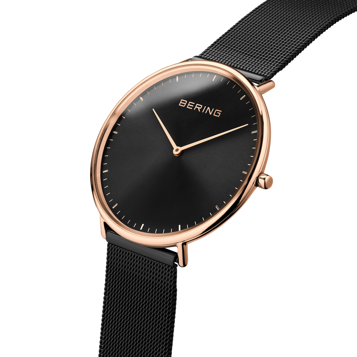 Angled close-up of the black dial and rose-tone case beside the black mesh strap.