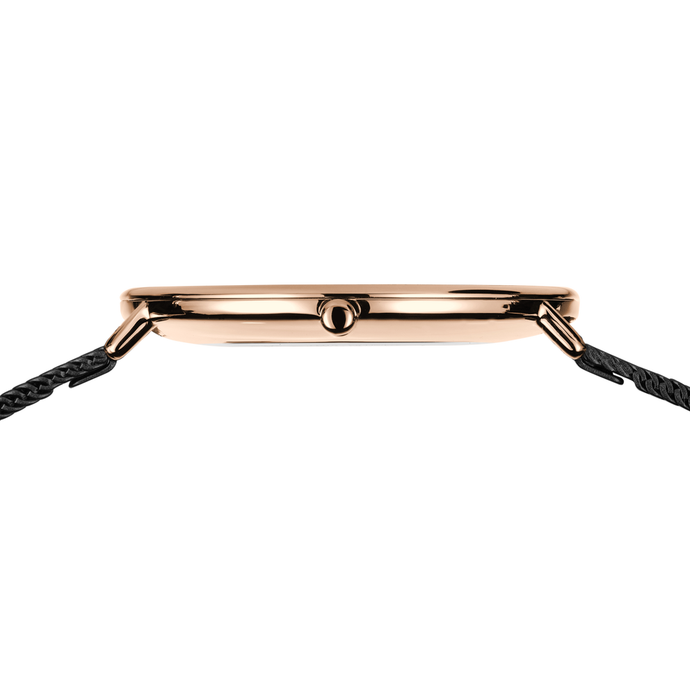 Side profile of the rose-tone watch case and crown between the ends of the black mesh strap.