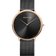 Front view: black dial, rose-tone case and black mesh strap.