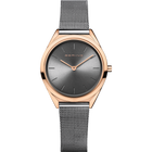 Reloj BERING de frente: esfera gris, caja rosada y correa de malla gris.