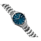 Diagonal overhead view of the textured blue dial, silver-tone case and silver-tone link bracelet.
