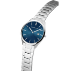 Angled close-up of the textured blue dial and silver-tone case beside the silver-tone link bracelet.