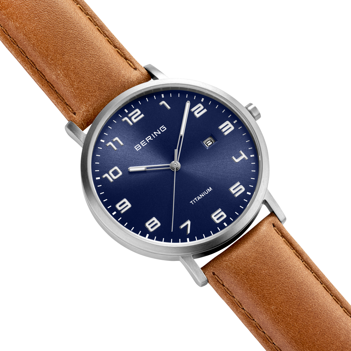 Diagonal overhead view of the blue dial with white numerals, silver-tone case and stitched brown strap.