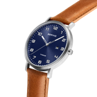 Angled close-up of the blue dial with white numerals and silver-tone case beside the stitched brown strap.