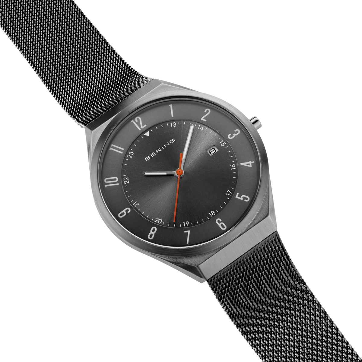 Diagonal overhead view of the grey dial with an orange hand, grey case and grey mesh strap.