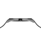 Side profile of the grey watch case and crown between the ends of the grey mesh strap.