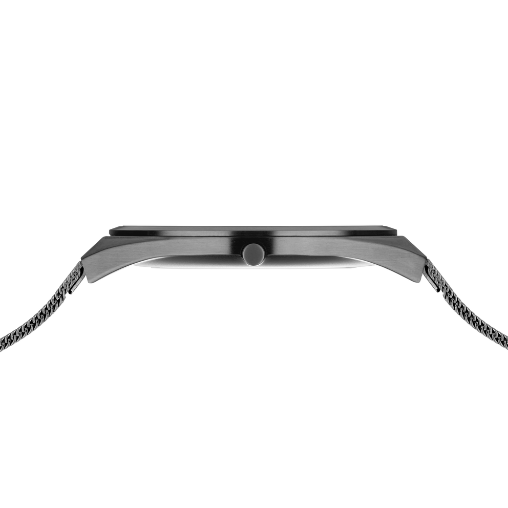 Side profile of the grey watch case and crown between the ends of the grey mesh strap.