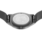 Engraved watch case back with the grey mesh strap extended to either side.