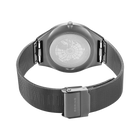 Rear view of the watch with its grey mesh strap looped and fastener closed.