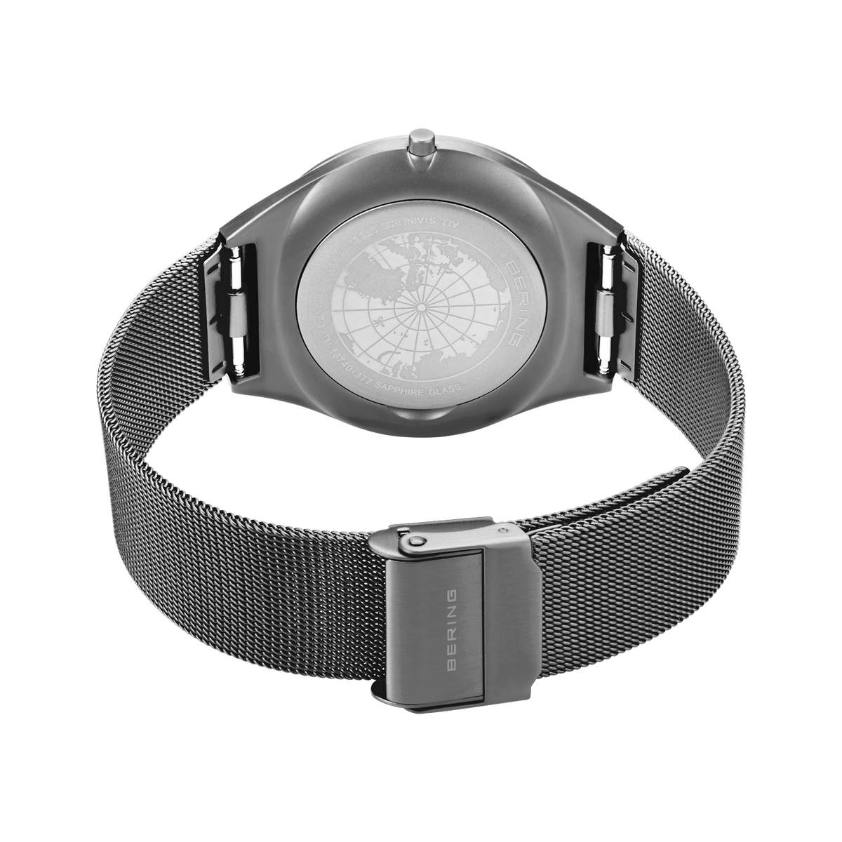 Rear view of the watch with its grey mesh strap looped and fastener closed.